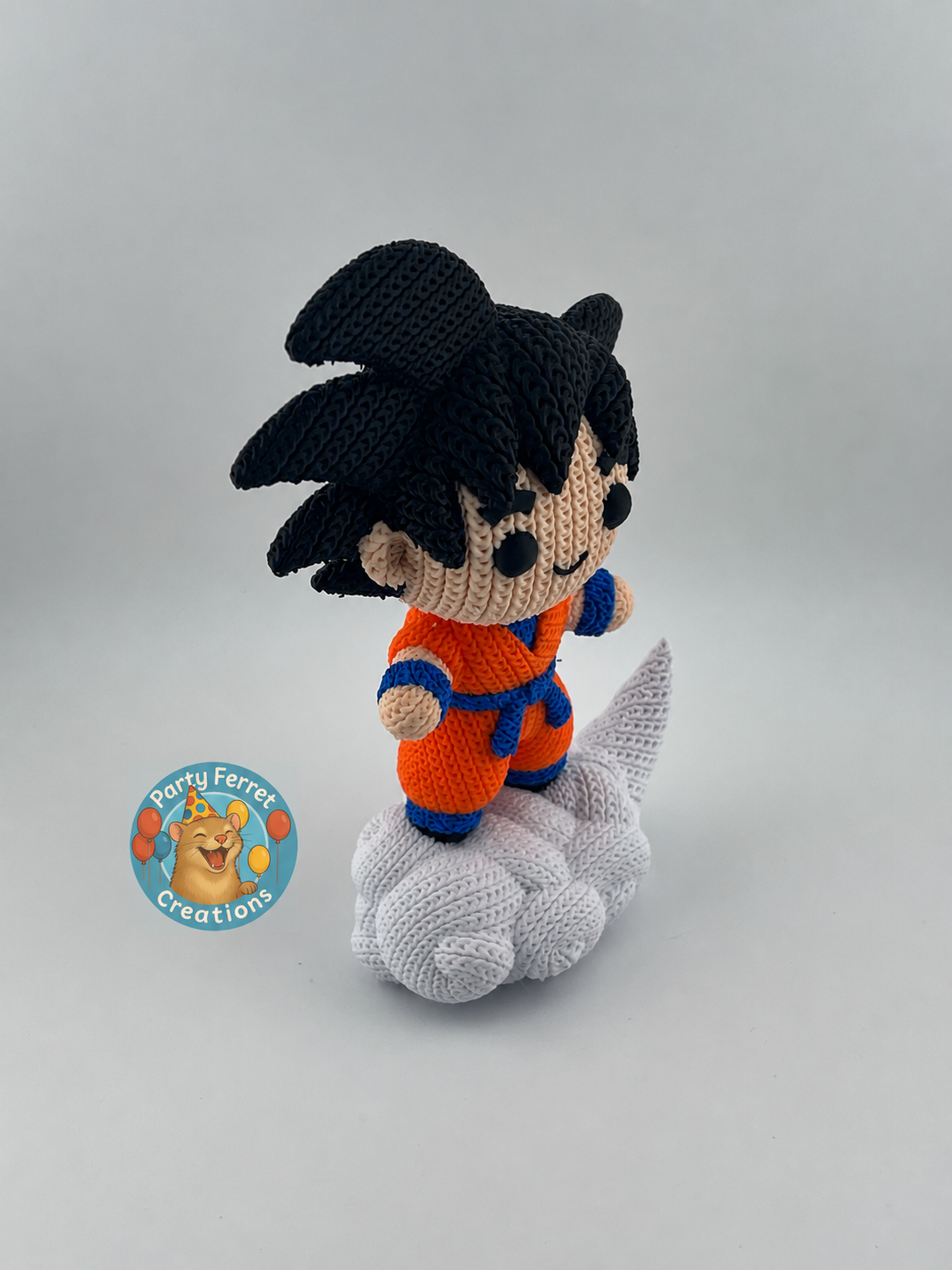 Side view of crochet-style 3D-printed Goku on Nimbus with Party Ferret Creations watermark