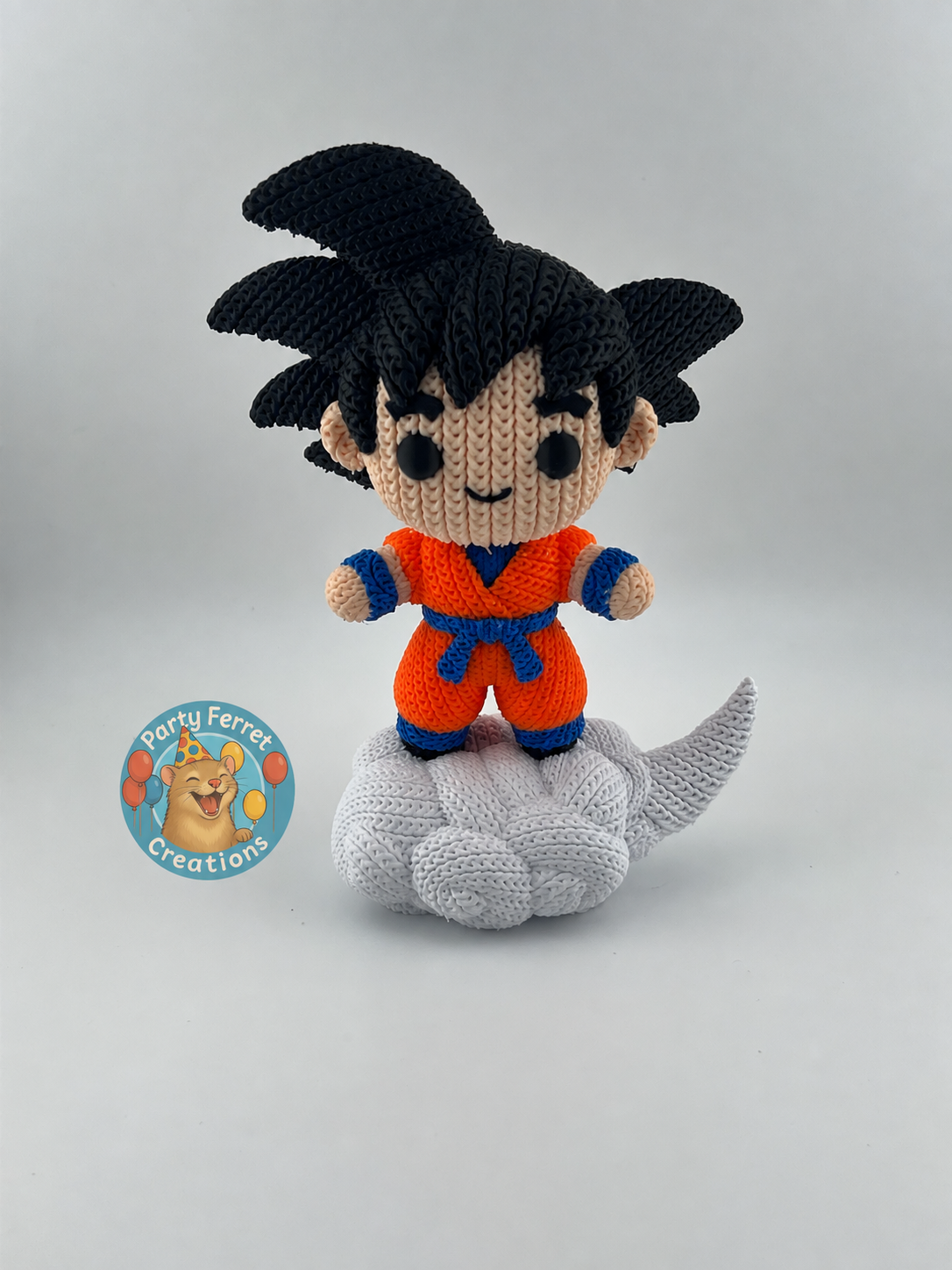 Crochet-style 3D-printed Goku on Nimbus with Party Ferret Creations watermark