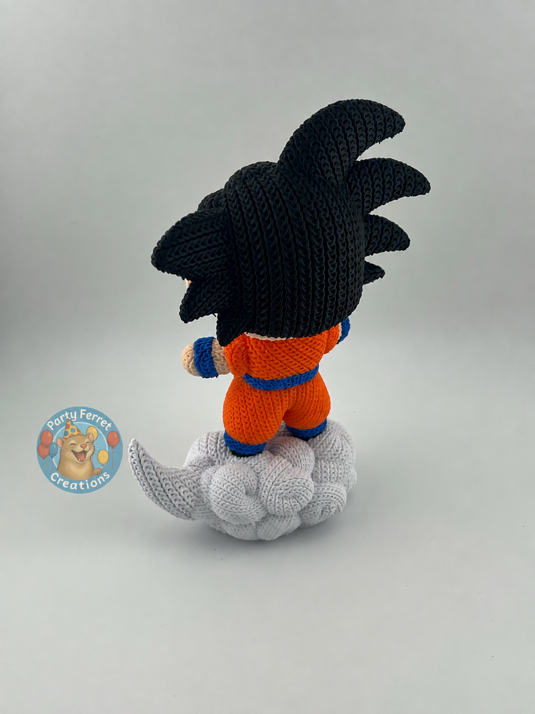Rear view of crochet-style 3D-printed Goku on Nimbus with Party Ferret Creations watermark