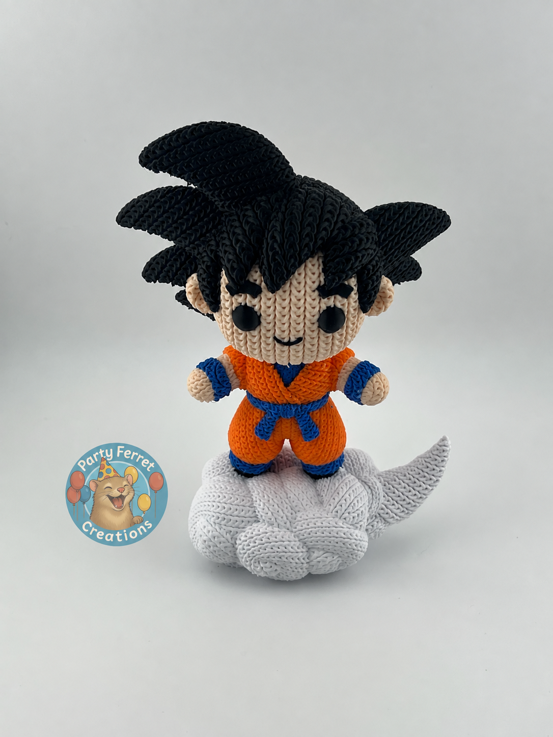 Crochet-style 3D-printed Goku on Nimbus with Party Ferret Creations watermark