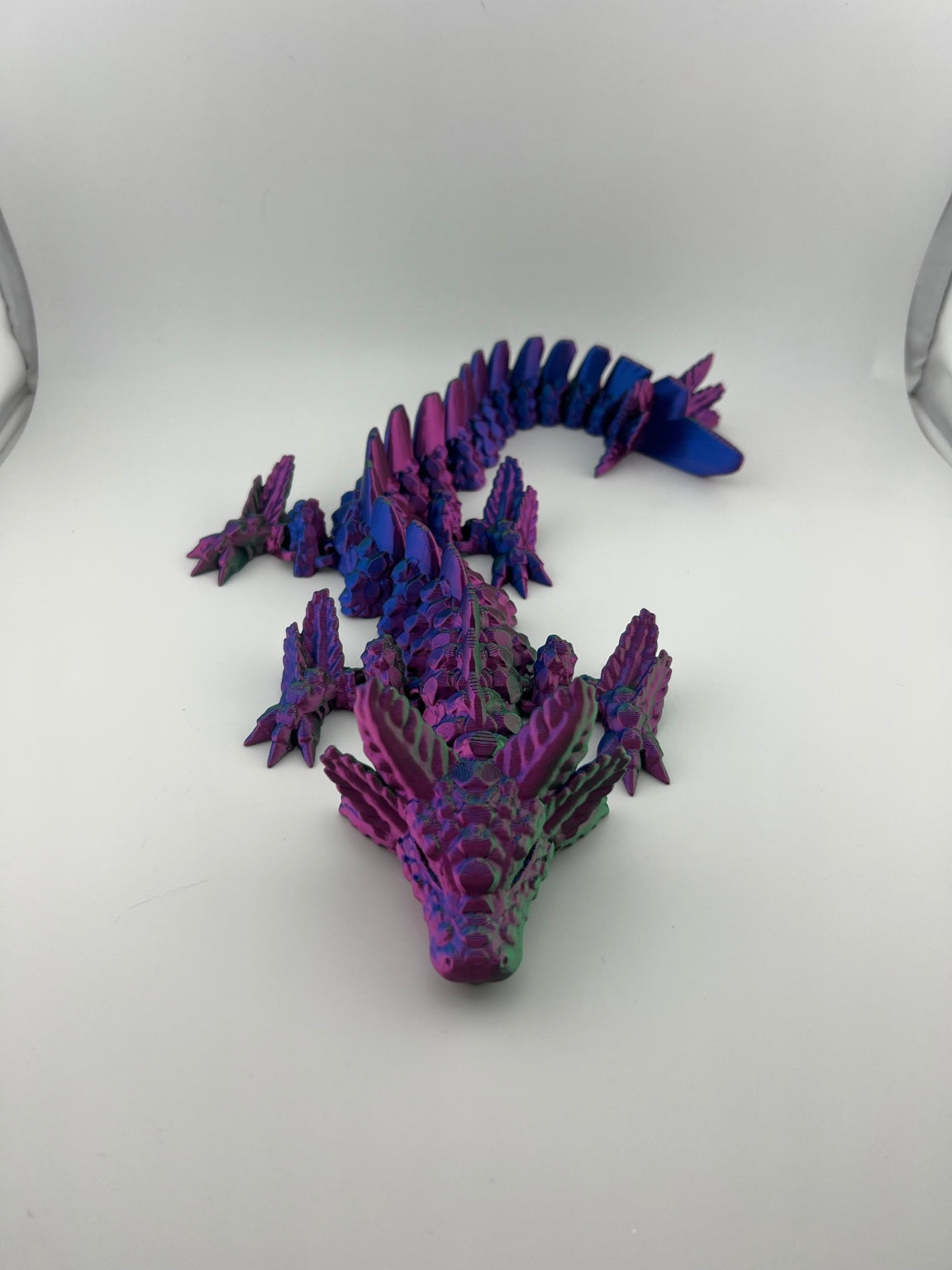 Articulated multicolor axolotl dragon with purple, blue, and green detailing